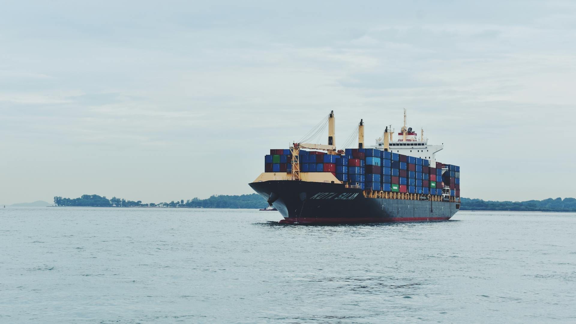 Large container cargo ship transporting containers across a calm sea
