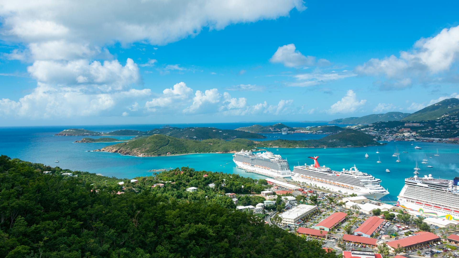 Aerial view of cruise ships docked in a turquoise Caribbean harbor