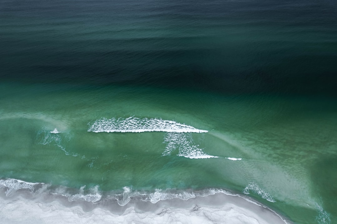 Aerial view of waves breaking over open coastal water